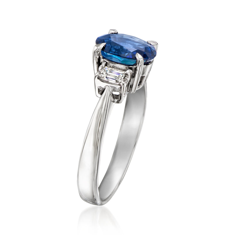 Platinum ring with tilted oval blue sapphire and square diamond accents