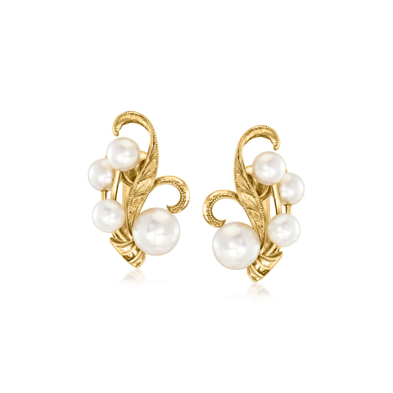 Gold-tone swirl clip earrings with white cultured pearls, four stones visible