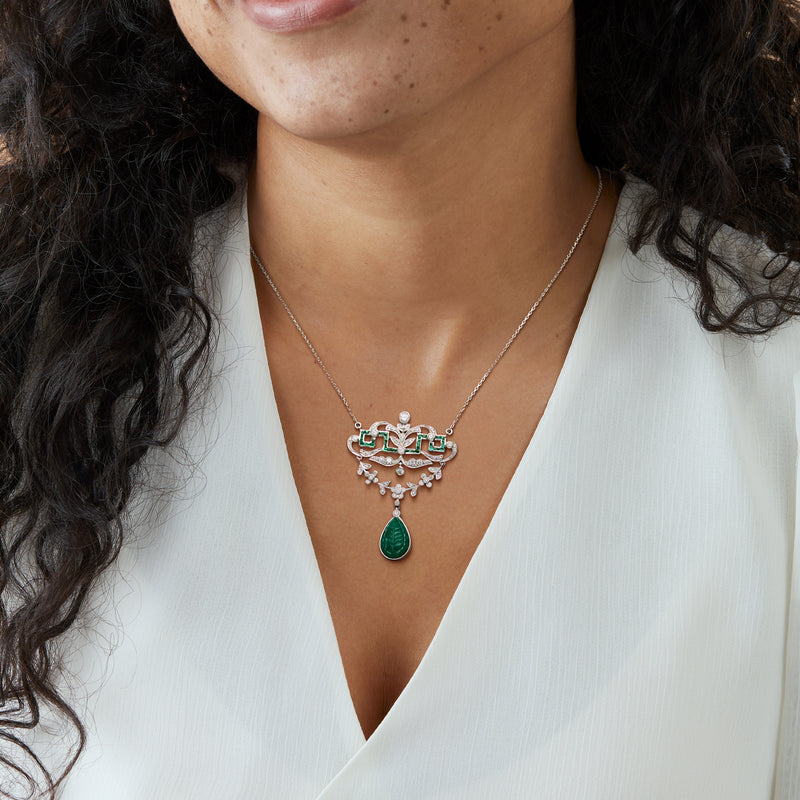 Openwork drop necklace on model: white gold chain with emerald teardrop pendant and diamonds