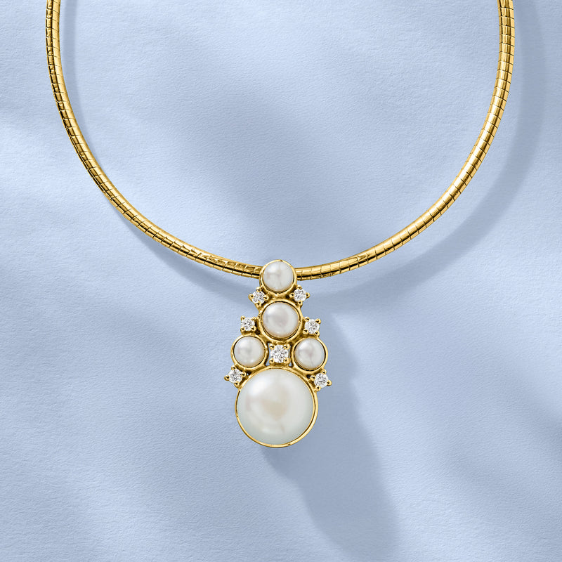 Gold pendant necklace with round pearls, halo stones, and a large center pearl