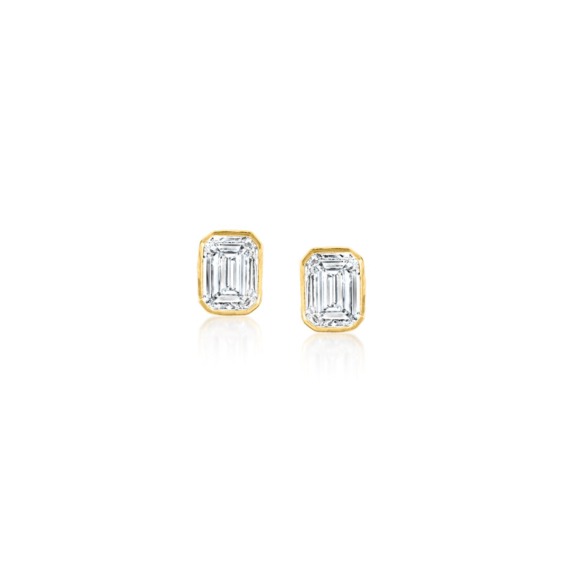 Emerald-cut diamond stud earrings in gold setting with square faceted stones