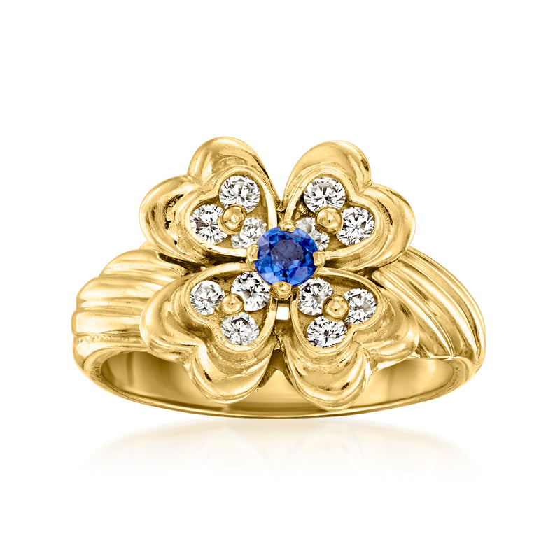 Yellow gold four-leaf clover ring with blue sapphire center and diamond accents
