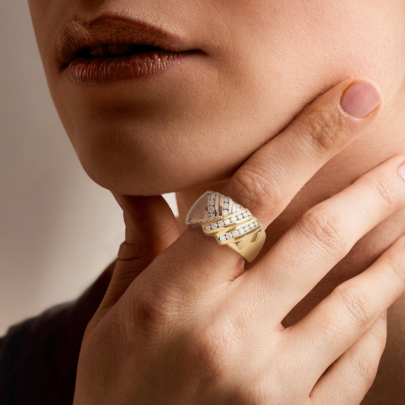 Two-tone gold crisscross diamond ring on finger, silver top with diamond rows