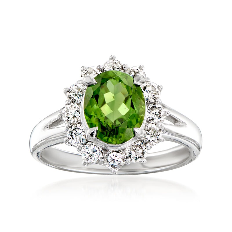 Platinum ring with oval green tourmaline center and diamond halo cluster