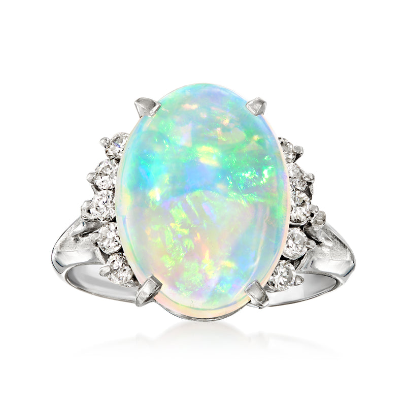 Vintage oval opal and diamond ring in platinum, oval opal center with side diamonds