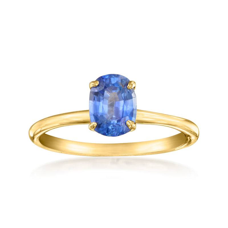 Yellow gold sapphire ring with oval blue prong-set gemstone on slim band