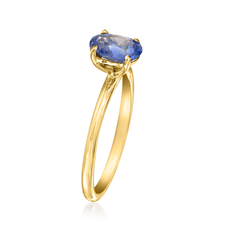 Yellow gold sapphire ring with oval blue center stone in four prongs, slim band