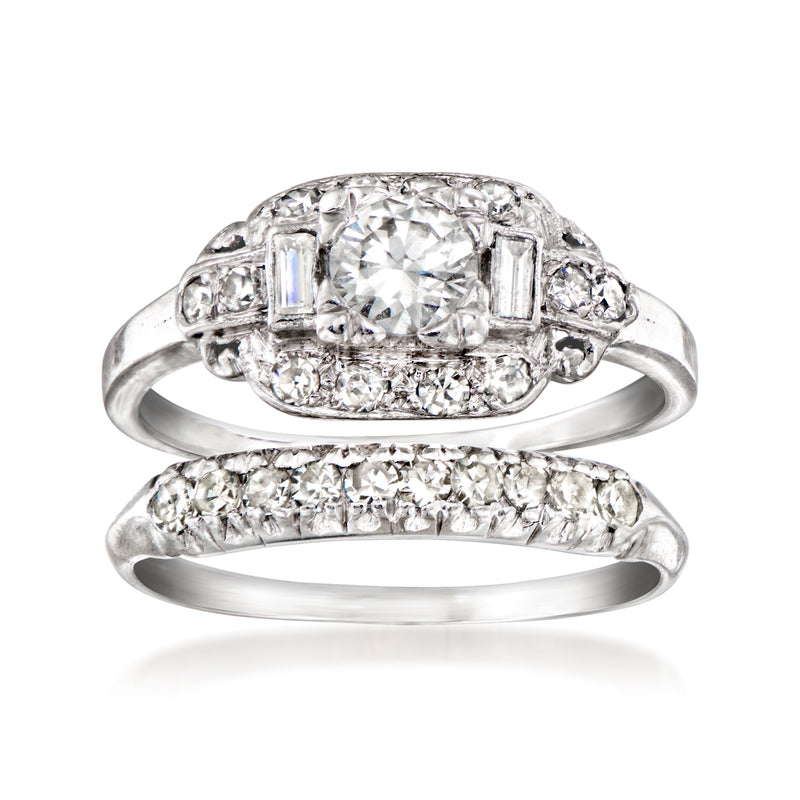 Platinum diamond bridal set with oval center engagement ring and pave wedding band