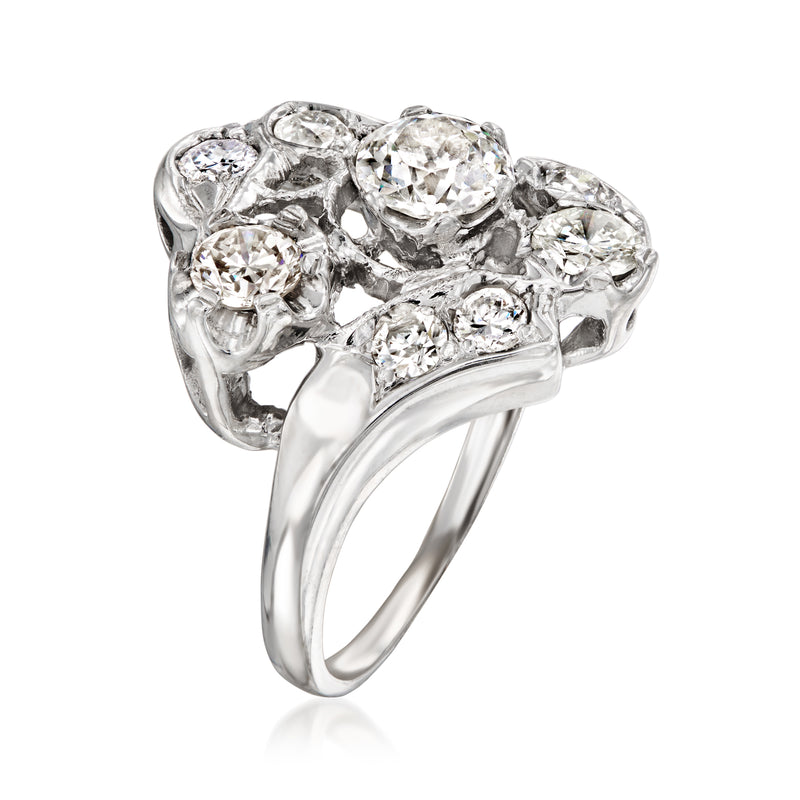 Vintage white gold diamond cluster ring with multiple round stones and curved band