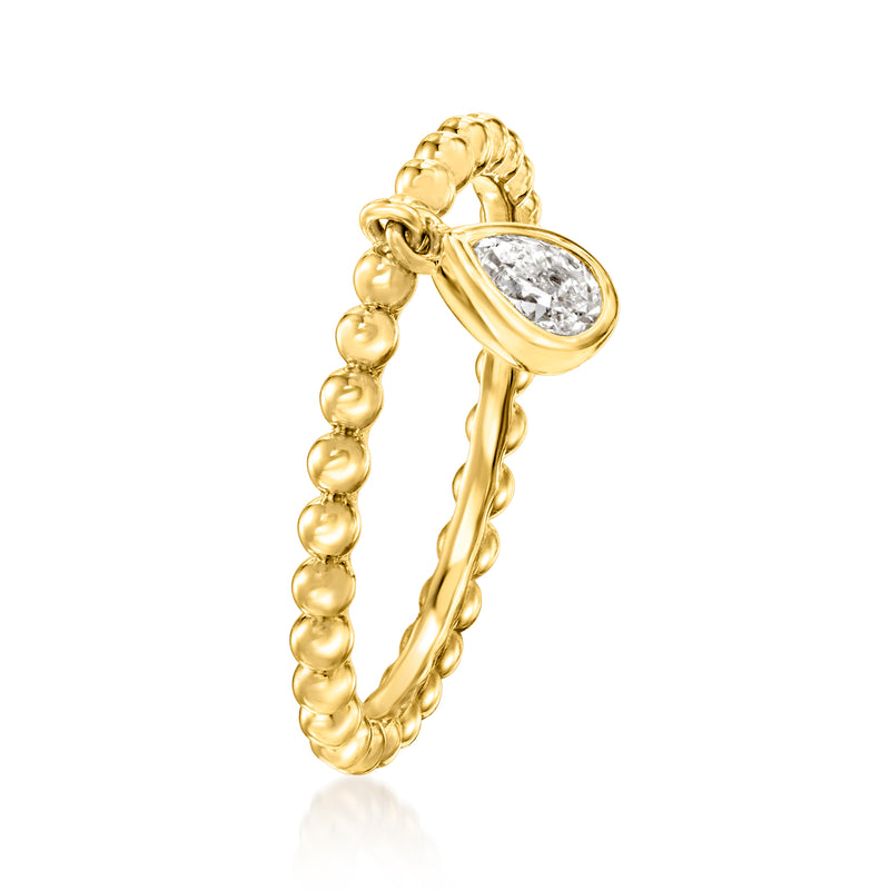 Gold beaded band ring with pear-shaped clear gemstone charm, angled view