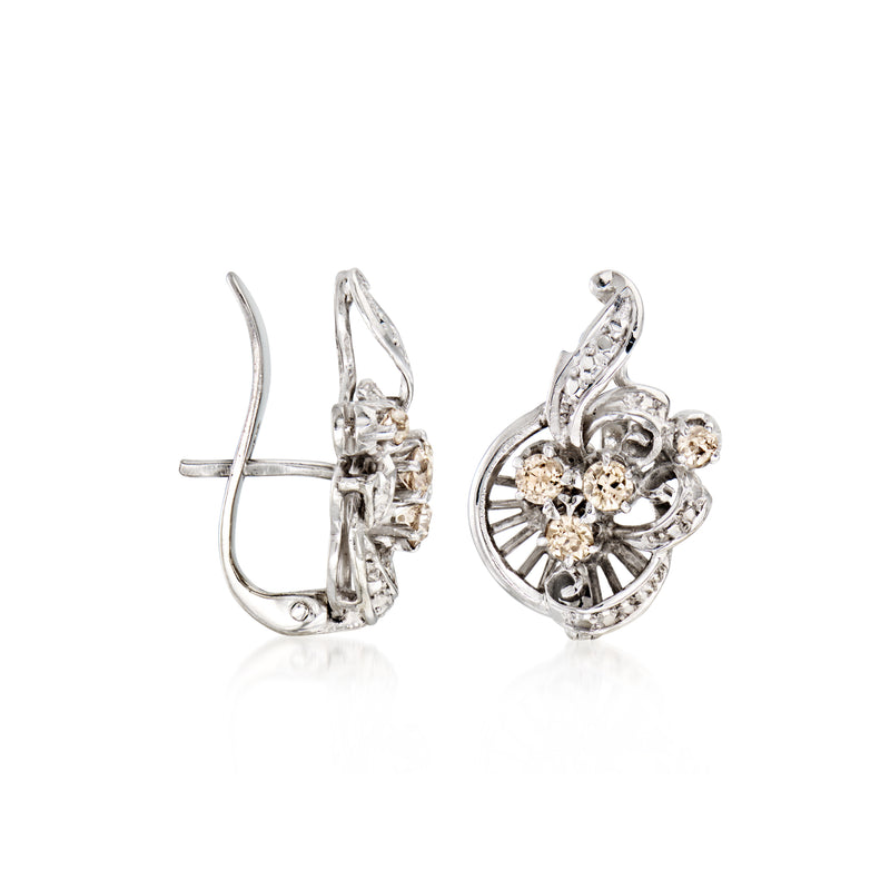 Swirl diamond stud earrings in 10kt white gold, post backs visible, ornate setting