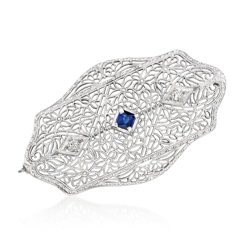 Vintage filigree white gold pin with blue sapphire center and small diamond accents