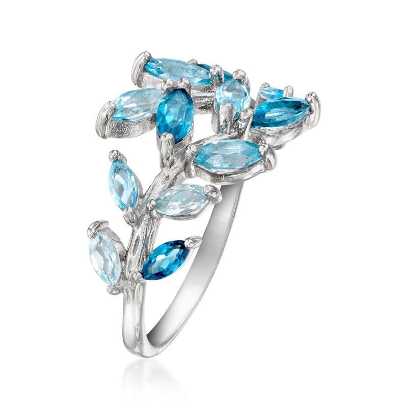 Sterling silver vine ring with prong-set oval blue topaz stones, side view.