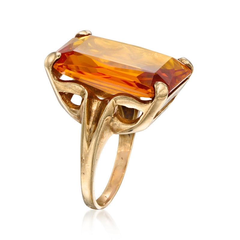10kt yellow gold ring with orange gemstone in tilted setting, open gallery sides