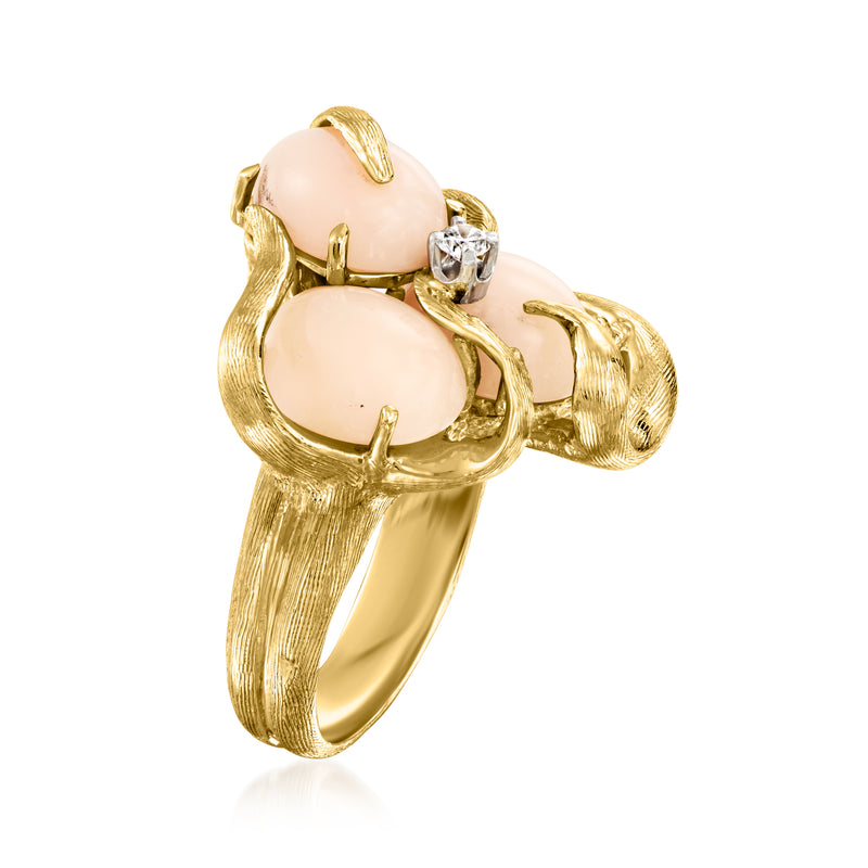 Vintage gold ring with sculpted pink coral panels and one round diamond centerpiece