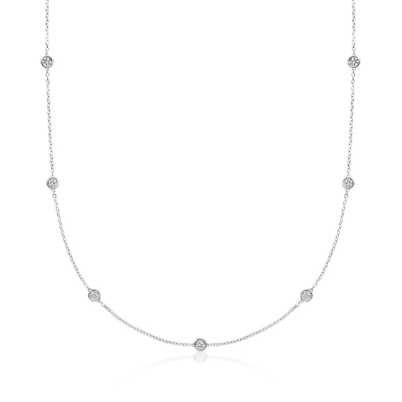 Sterling silver diamond station necklace with bezel-set round stones on a chain