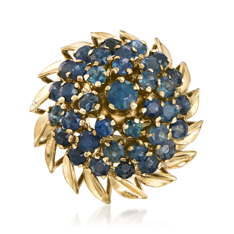 Yellow gold sapphire cluster ring with blue oval and round stones, raised prongs