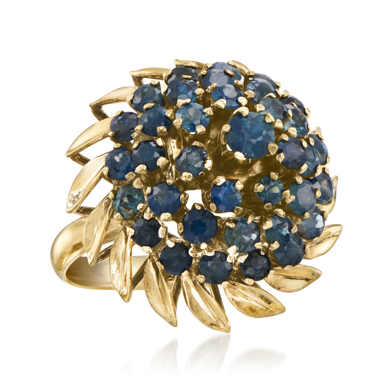 Yellow gold sapphire cluster ring with round blue stones and gold leaf-like accents