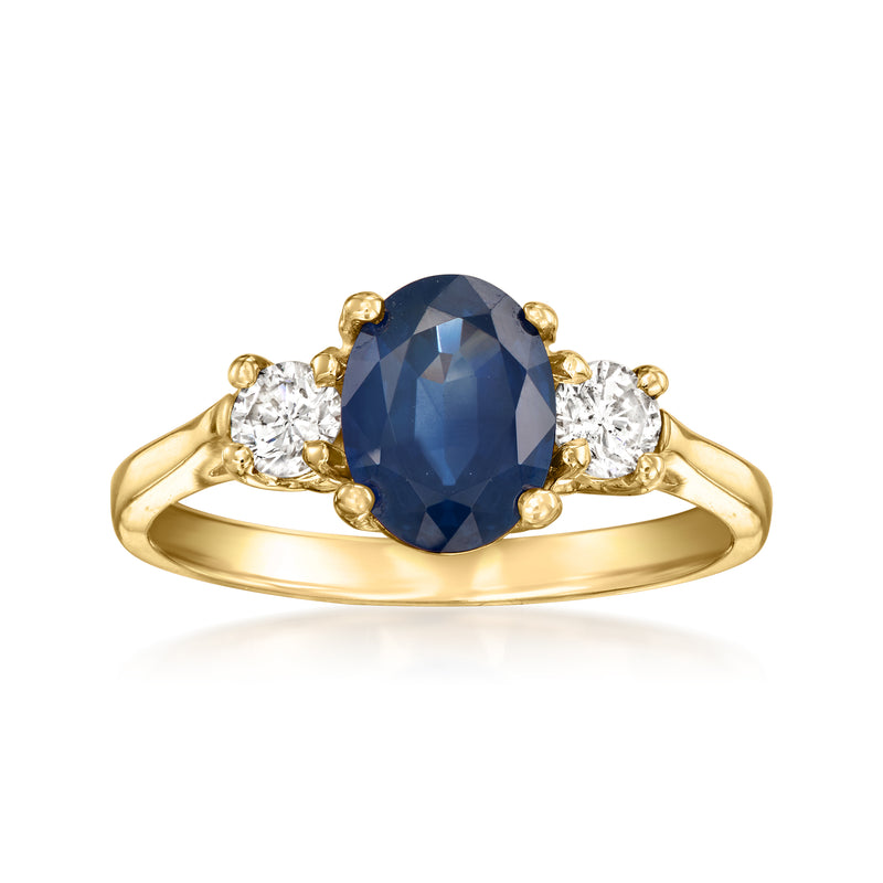 14kt yellow gold vintage ring with large oval blue sapphire and three diamond accents