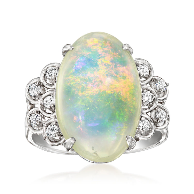 Oval opal ring with round diamond halo in platinum setting