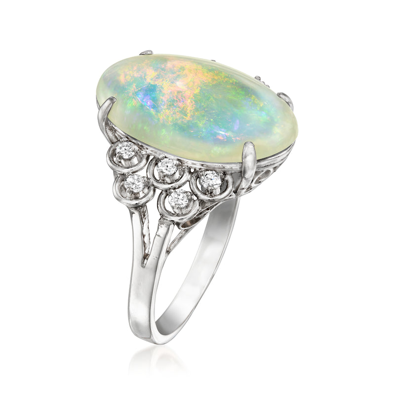 Oval opal cabochon ring with diamond side cluster and openwork platinum band
