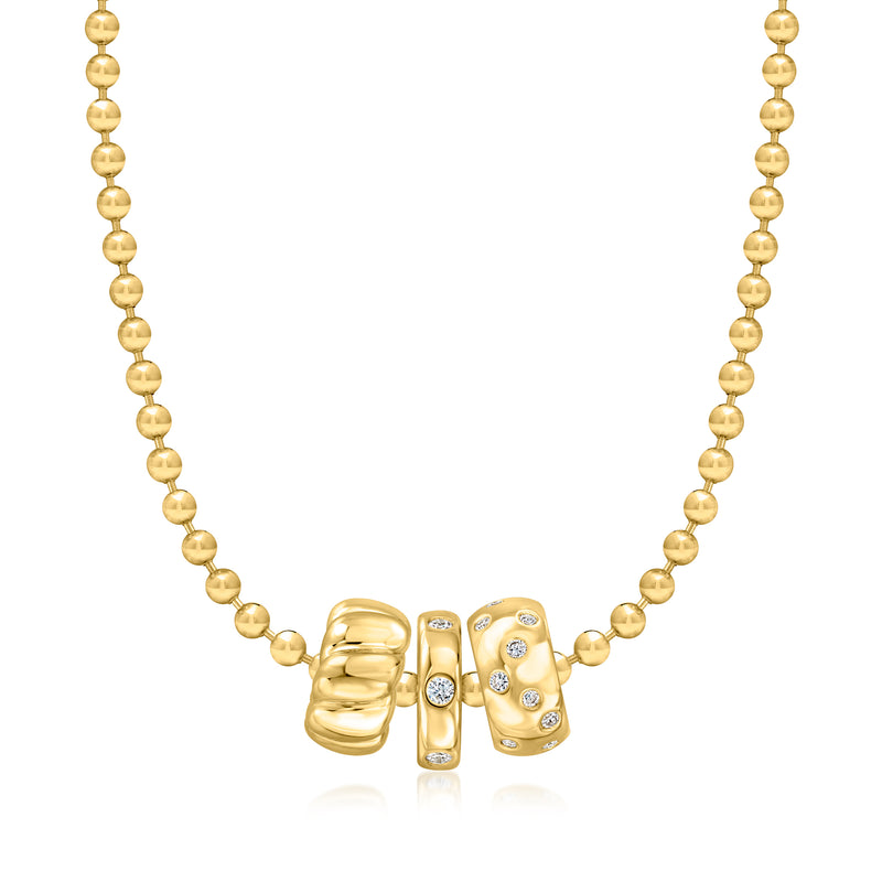 Gold beaded necklace featuring three-section diamond bead charm