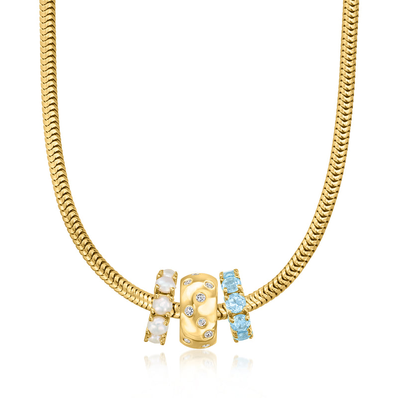 Gold chain necklace with gold diamond bead charm, white stones, and blue rectangular accents