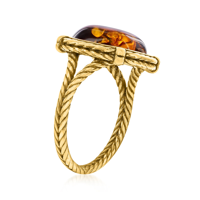 Amber ring side view with oval amber stone in gold bezel and twisted rope band