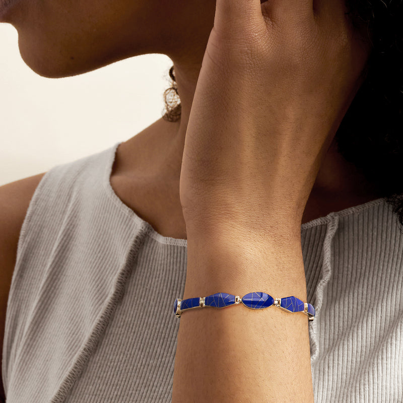 Lapis mosaic bracelet on wrist, blue panels with oval center in yellow gold