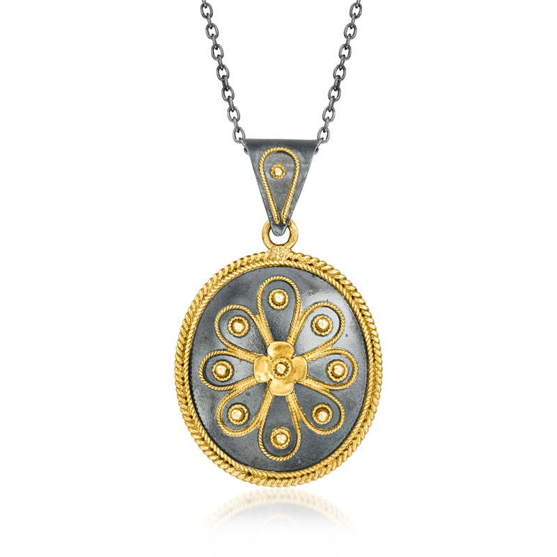 Round pendant necklace with gold filigree and dark enamel, sterling silver chain