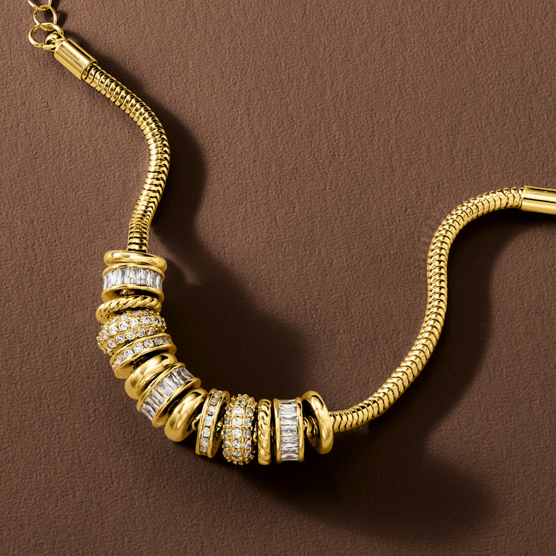 Gold-plated bead charm bracelet close-up with white CZ bands and ribbed links