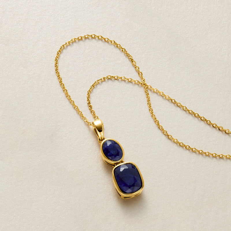 Gold double-drop pendant with faceted blue sapphire stones on linked chain