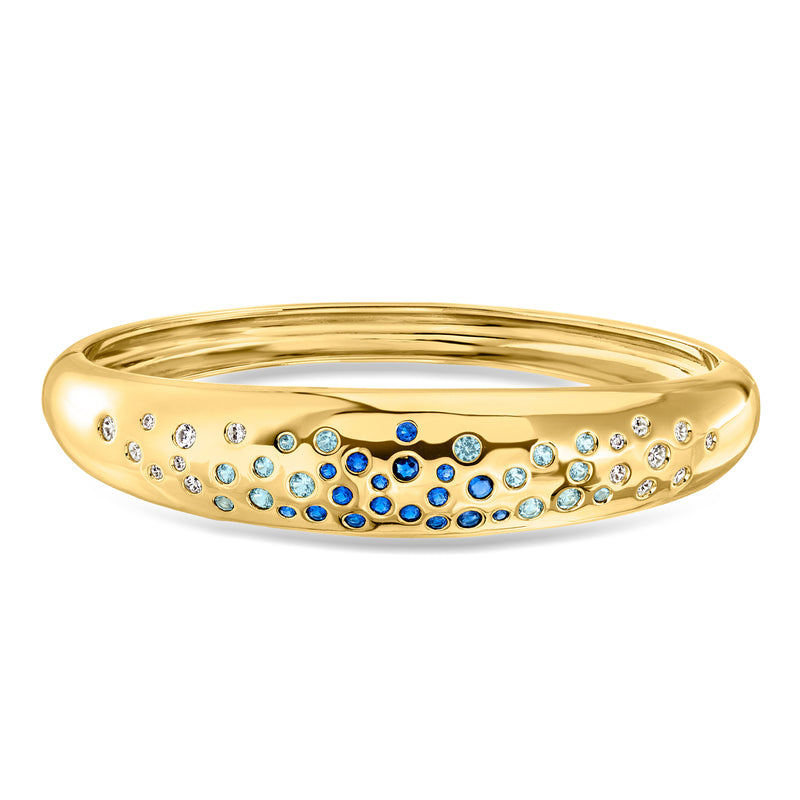 Gold-plated bangle bracelet with blue and white simulated gemstones in a row