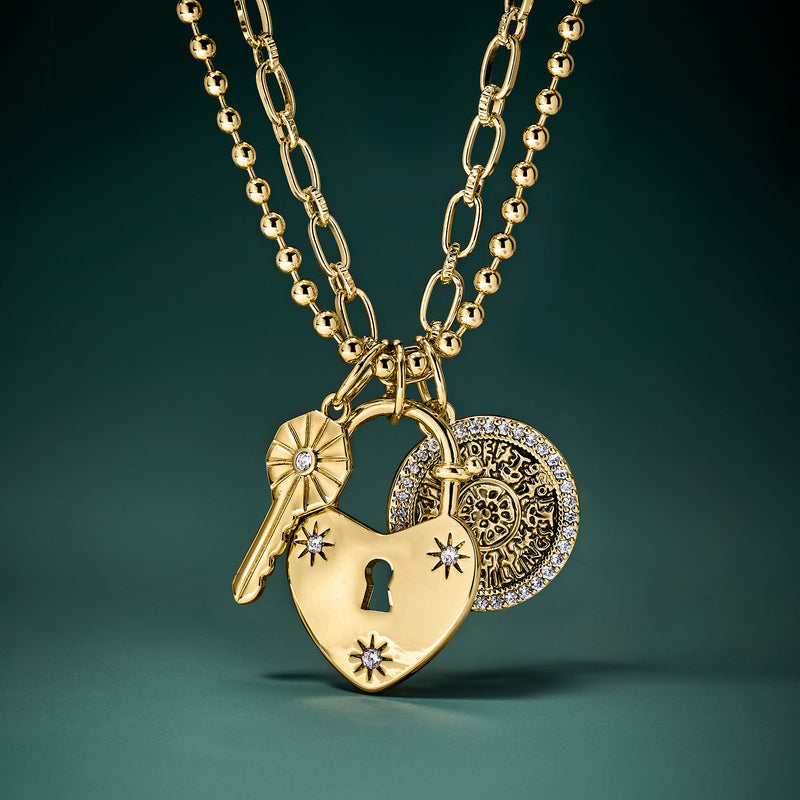 Gold-plated key, heart lock, and coin charm necklace with sparkling CZ details