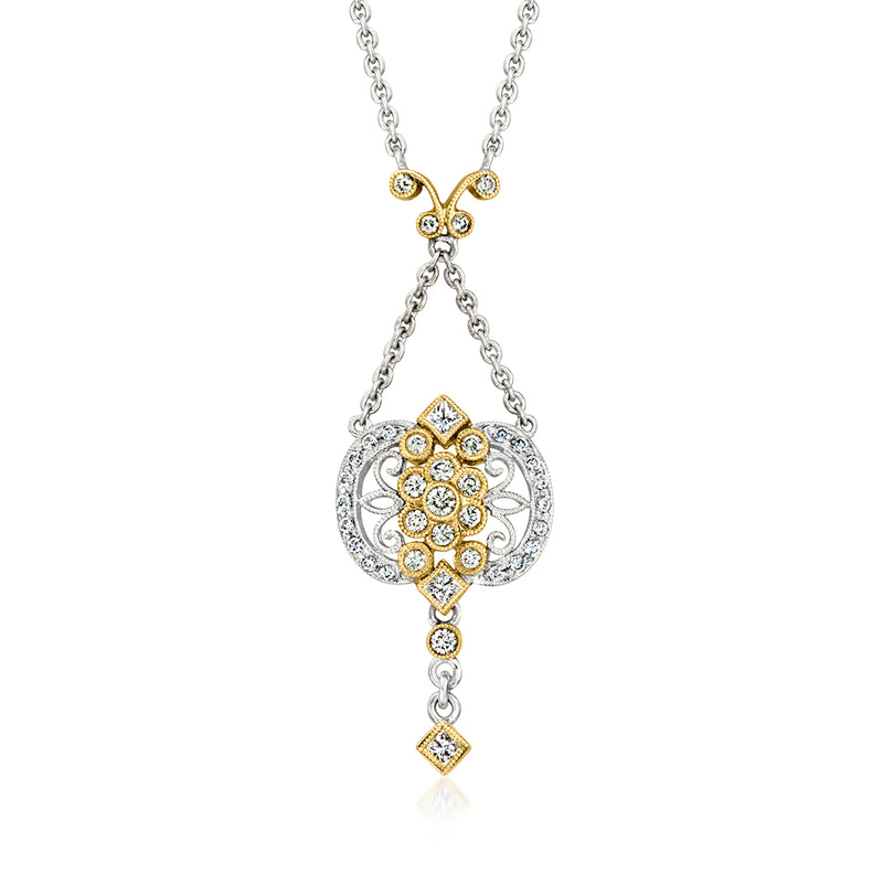 Two-tone gold diamond drop necklace with round halo pendant and dangling diamond charm