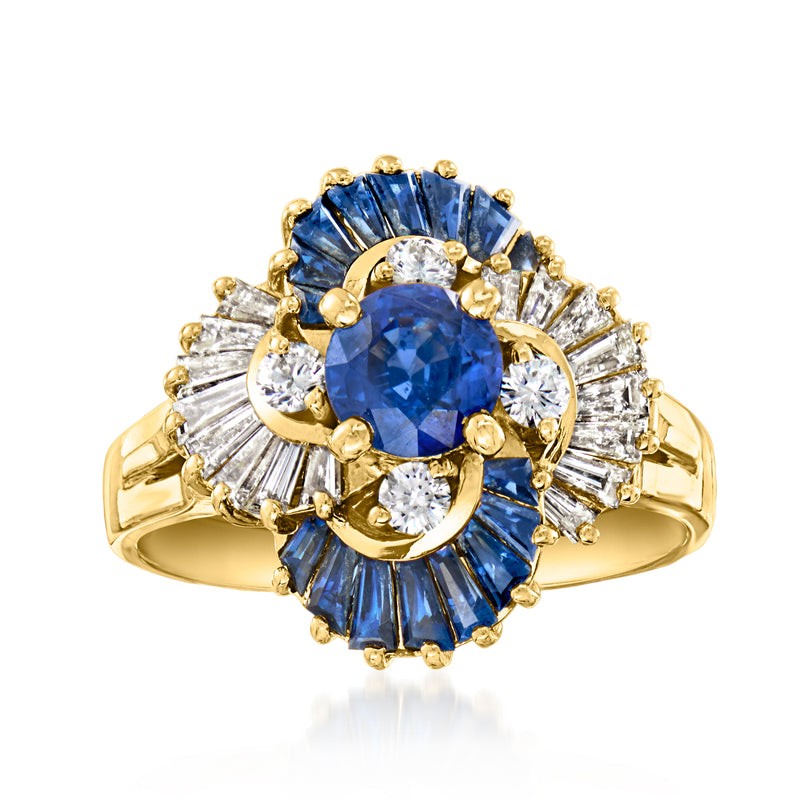 18kt yellow gold ring with oval blue sapphire center and diamond swirl halo