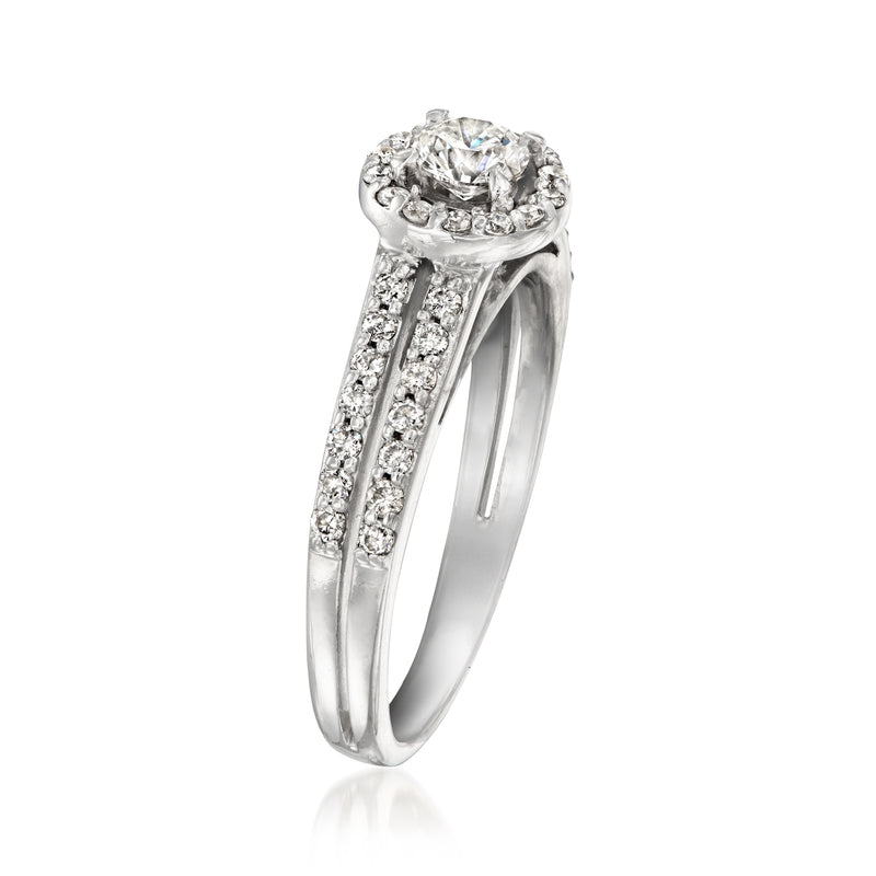 White gold vintage ring with round diamond center and raised halo, side view