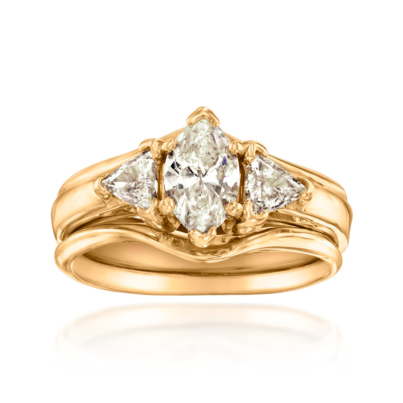 Three-stone diamond ring with central oval stone and two side diamonds in yellow gold