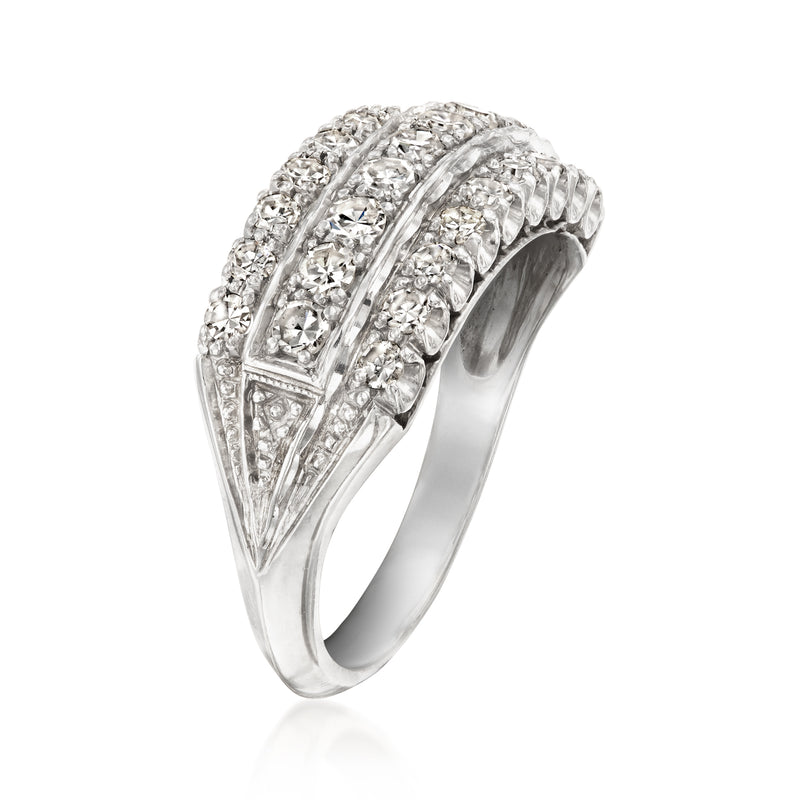 Three-row prong-set diamond ring in white gold, curved profile with scalloped edges.