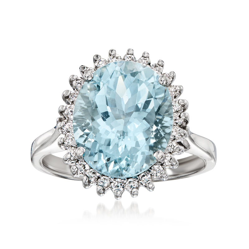 Vintage aquamarine halo diamond ring in 14kt white gold; oval light-blue center, round diamonds