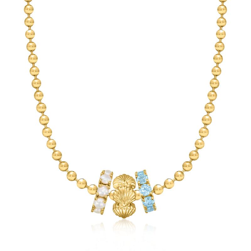 Gold beaded necklace with seashell charm drop and blue ribbon-like accents