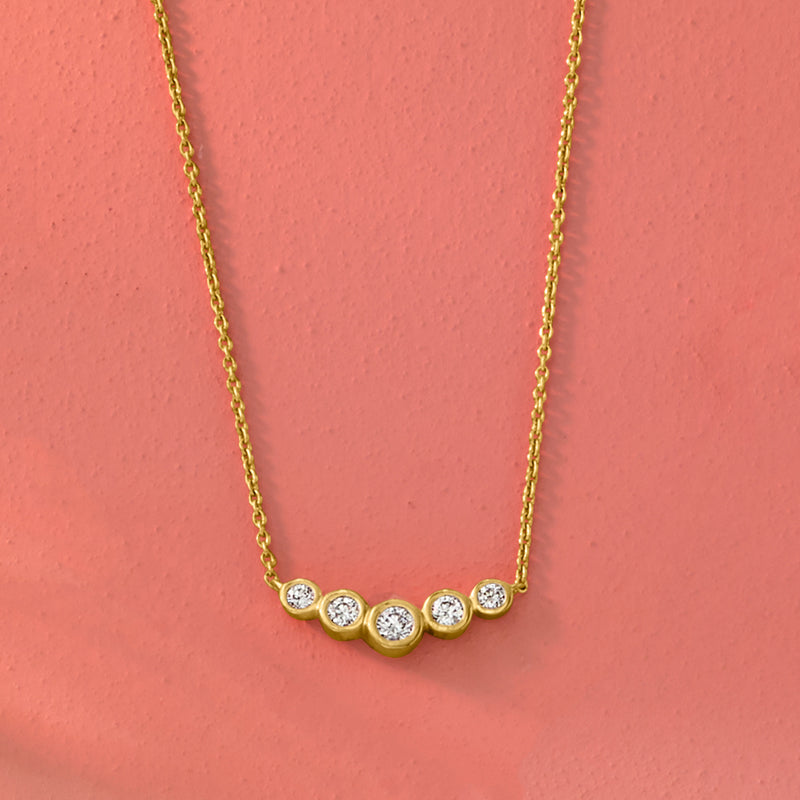 Gold bar necklace with row of round bezel-set diamonds on a fine chain