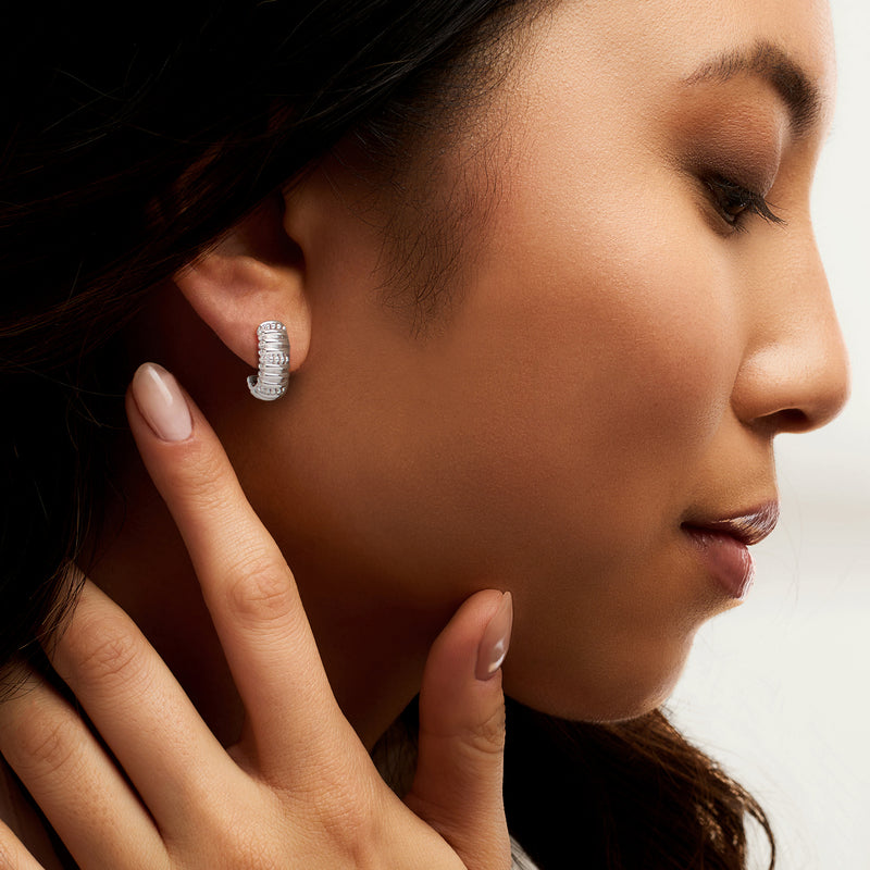 Sterling silver J-hoop earrings on ear, stacked scalloped spiral design