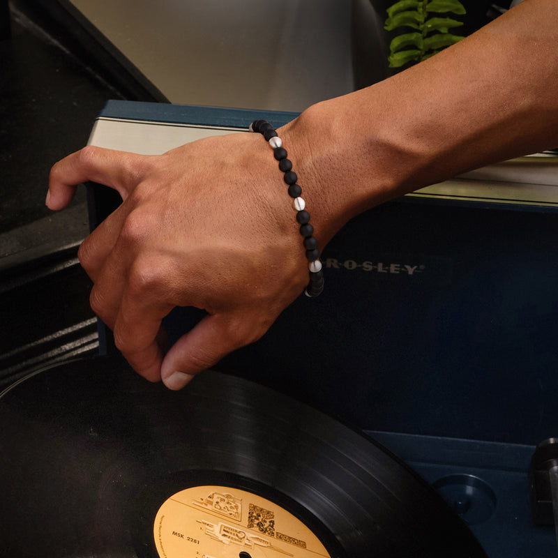 Men's black bead bracelet with sterling silver clasp worn on wrist
