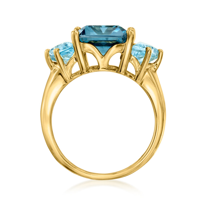 Gold ring with elevated prongs holding an emerald-cut sky blue topaz solitaire