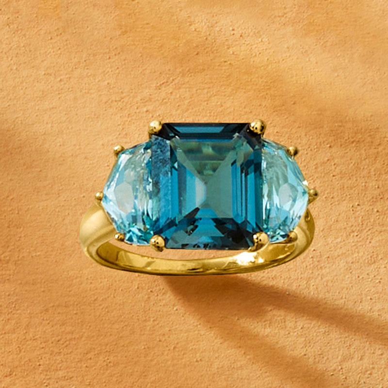 Gold ring with emerald-cut sky blue topaz centerpiece and small round detail prongs