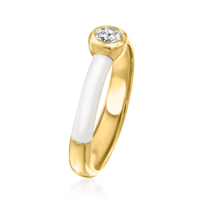 Bezel-set round diamond ring with gold band and white enamel panels, side view.