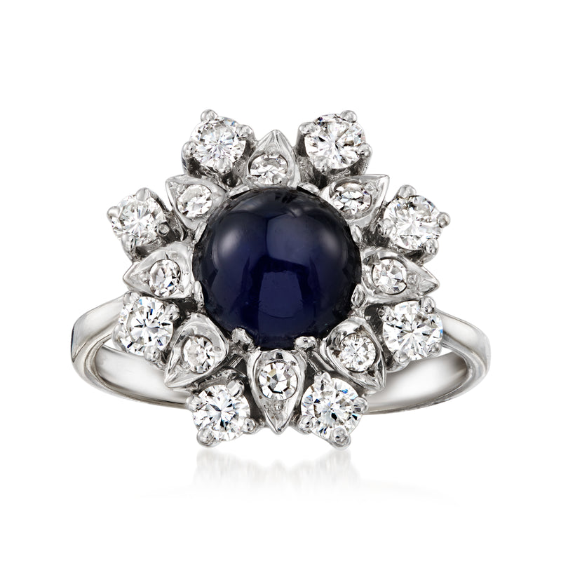 White gold oval sapphire ring with sparkling round diamonds in a halo cluster