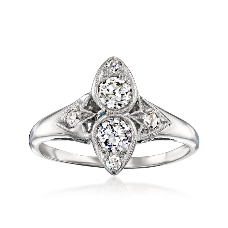 Platinum vintage diamond ring with round center and marquise side stones