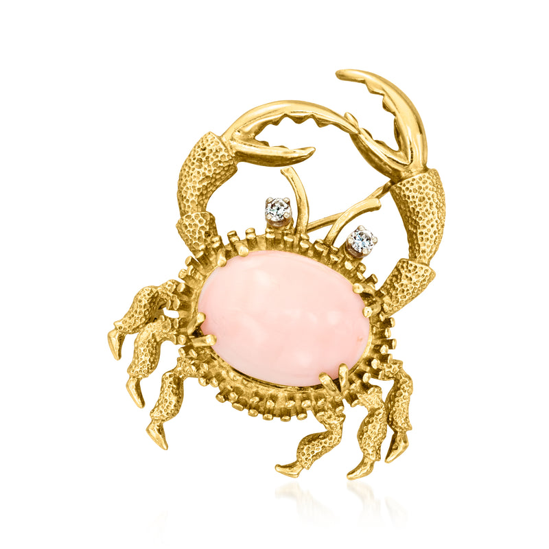 Gold crab pin with round pink coral cabochon and small clear stone accents